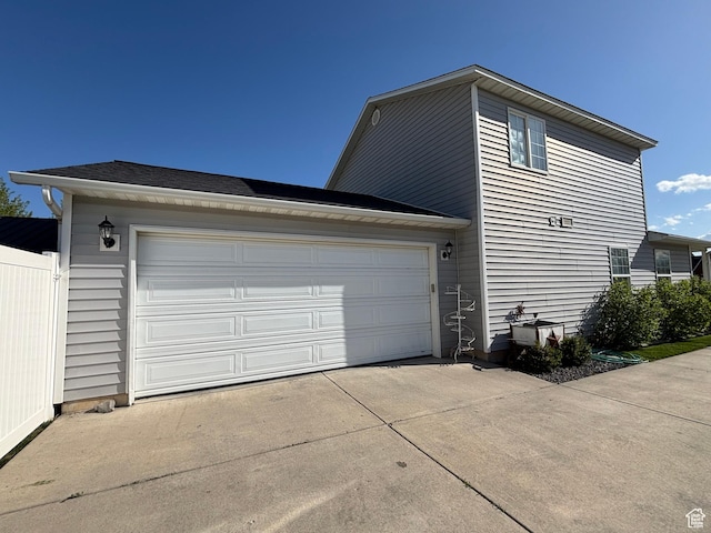view of side of property with driveway and a garage