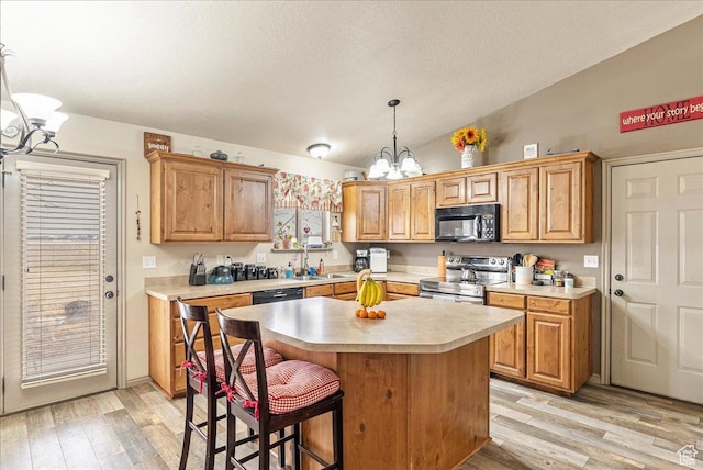 4323 W 25 S, West Point, UT 84015 - kitchen with a kitchen island, pendant lighting, lofted ceiling, stainless steel range with electric stovetop, and an inviting chandelier