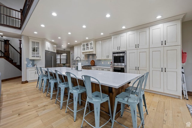 1532 W 3500 N, Pleasant Grove, UT 84062 - kitchen with stainless steel appliances, backsplash, recessed lighting, light wood-type flooring, and white cabinets