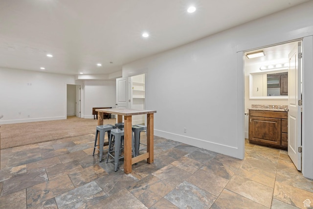 1532 W 3500 N, Pleasant Grove, UT 84062 - kitchen with stone finish flooring, baseboards, recessed lighting, a sink, and light countertops