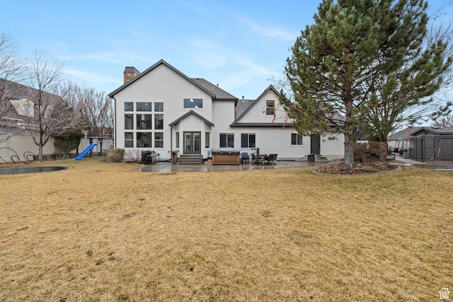 1532 W 3500 N, Pleasant Grove, UT 84062 - back of house featuring a chimney, entry steps, stucco siding, a patio area, and a playground