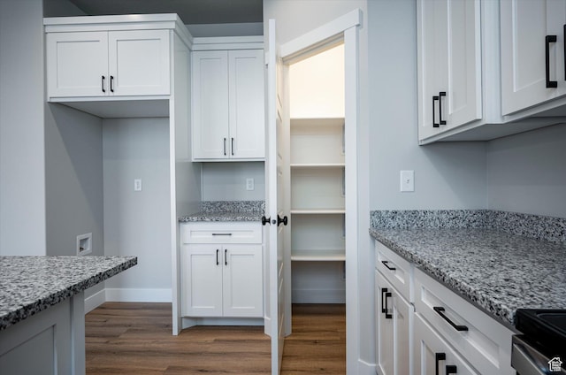 1357 N 450 W Unit 50, Brigham City, UT 84302 - kitchen with white cabinetry, hardwood / wood-style flooring, and light stone countertops