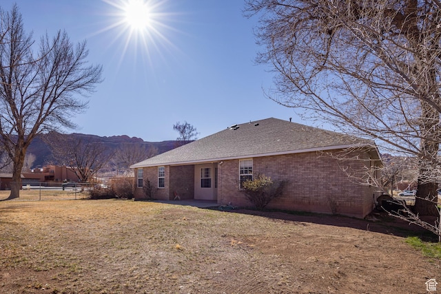 567 S 400 E, Moab, UT 84532 - back of house featuring a mountain view, brick siding, and a shingled roof