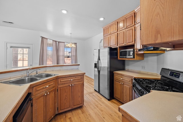 567 S 400 E, Moab, UT 84532 - kitchen featuring stainless steel appliances, a sink, light countertops, light wood finished floors, and healthy amount of natural light