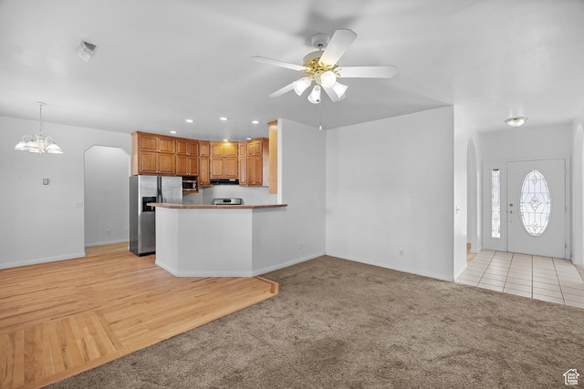 567 S 400 E, Moab, UT 84532 - kitchen with appliances with stainless steel finishes, arched walkways, light colored carpet, ceiling fan, and recessed lighting