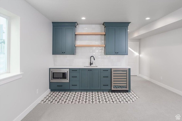 2998 N 1080 W, Lehi, UT 84043 - kitchen featuring light countertops, stainless steel microwave, wine cooler, tasteful backsplash, and a sink