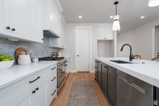 2998 N 1080 W, Lehi, UT 84043 - kitchen featuring white cabinetry, a sink, light wood-type flooring, and appliances with stainless steel finishes