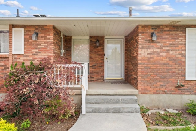 2283 E 7925 S, South Weber, UT 84405 - view of exterior entry featuring a porch and brick siding