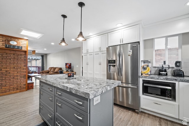 2283 E 7925 S, South Weber, UT 84405 - kitchen featuring gray cabinets, decorative light fixtures, white cabinets, light wood finished floors, and stainless steel appliances