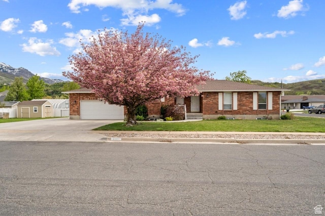 2283 E 7925 S, South Weber, UT 84405 - obstructed view of property featuring brick siding, a garage, a mountain view, and driveway