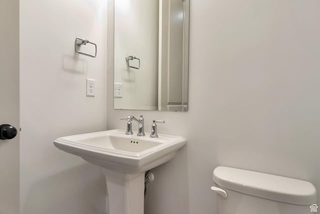 half bath with a sink and toilet