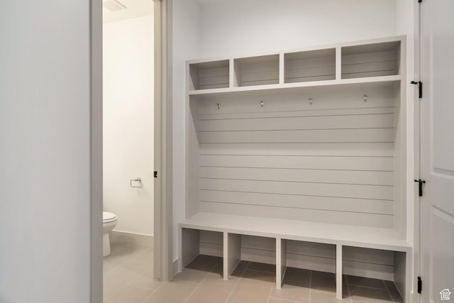 mudroom with tile patterned flooring and baseboards
