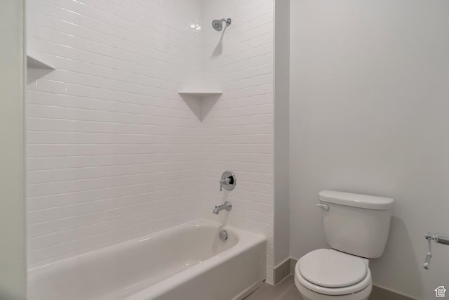 bathroom featuring baseboards, shower / bathtub combination, and toilet
