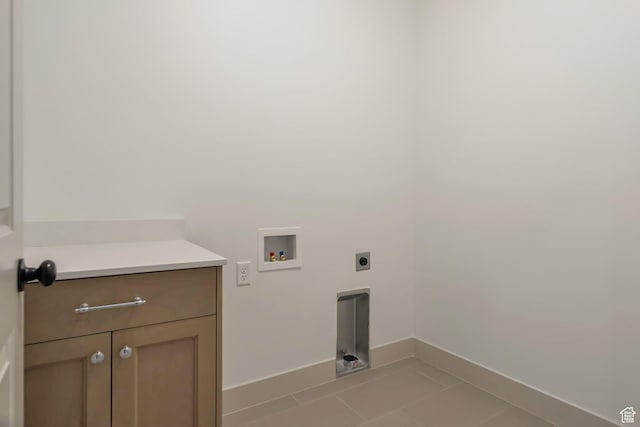 laundry room featuring electric dryer hookup, cabinet space, baseboards, hookup for a washing machine, and light tile patterned flooring