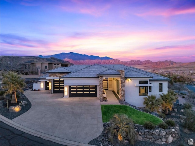 prairie-style house with a garage and a mountain view