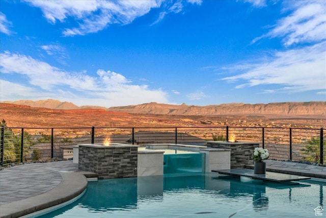 view of swimming pool with a mountain view