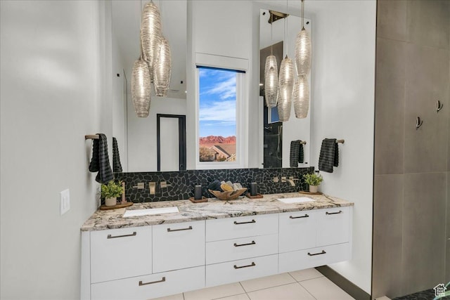 bathroom featuring vanity, tile patterned floors, and decorative backsplash
