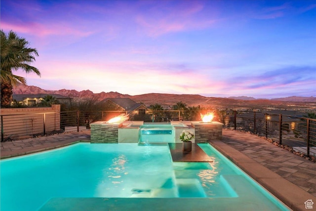 pool at dusk with a mountain view