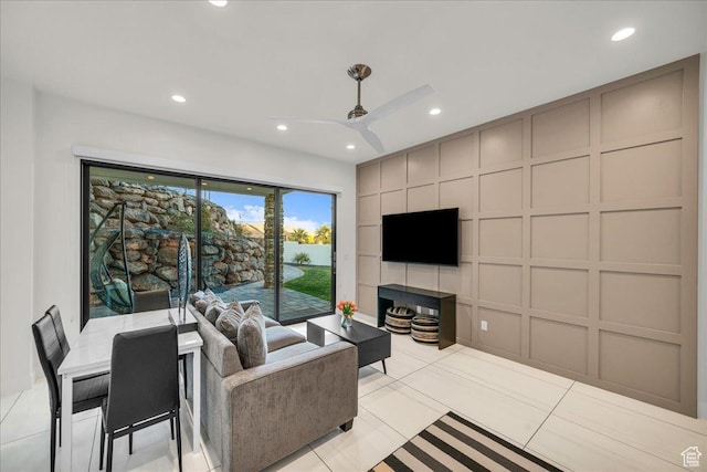 living room featuring light tile patterned floors and ceiling fan