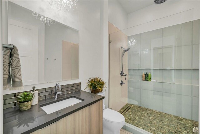 bathroom featuring an enclosed shower, vanity, and toilet