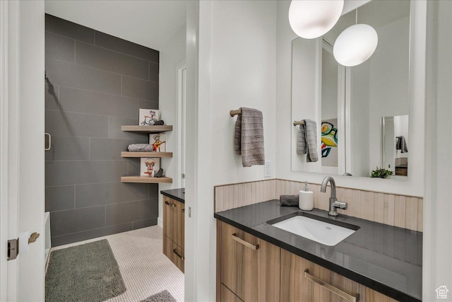bathroom with vanity and tile walls