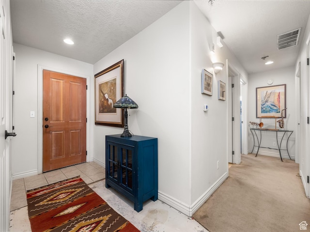 11085 S Grape Arbor Pl Unit 102, Sandy, UT 84070 - entryway with light carpet and a textured ceiling
