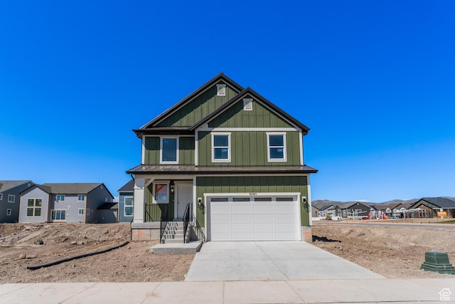 view of front of property with concrete driveway, a residential view, board and batten siding, and a garage