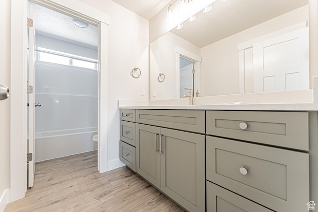 1091 N 3620 W Unit 272, Lehi, UT 84043 - bathroom with vanity, toilet, wood finished floors, shower / washtub combination, and baseboards