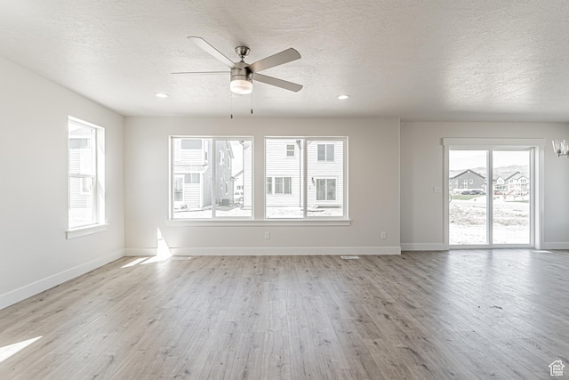 1091 N 3620 W Unit 272, Lehi, UT 84043 - empty room featuring a textured ceiling, light wood-type flooring, ceiling fan, baseboards, and recessed lighting