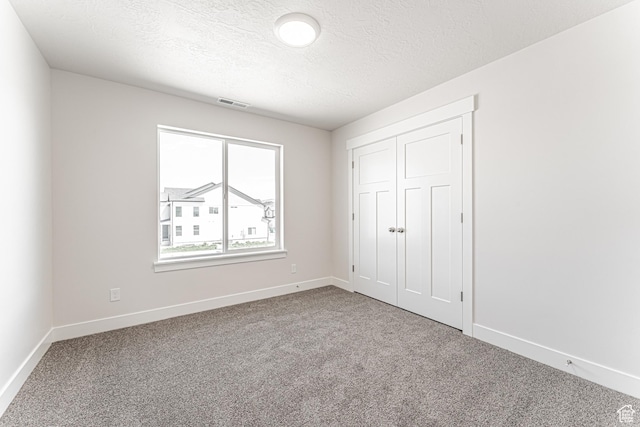 1091 N 3620 W Unit 272, Lehi, UT 84043 - unfurnished bedroom featuring carpet flooring, baseboards, a textured ceiling, and a closet
