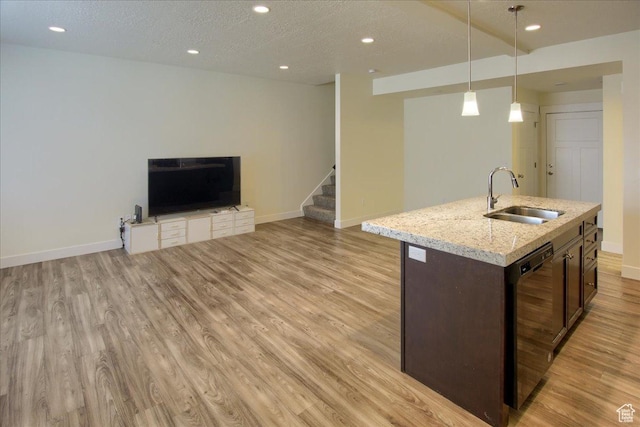 kitchen with decorative light fixtures, dishwasher, sink, light stone counters, and dark brown cabinets