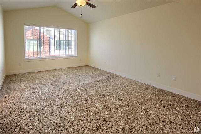 carpeted empty room with vaulted ceiling and ceiling fan