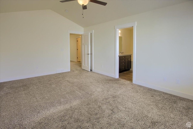 unfurnished bedroom with light carpet, lofted ceiling, ceiling fan, and ensuite bathroom