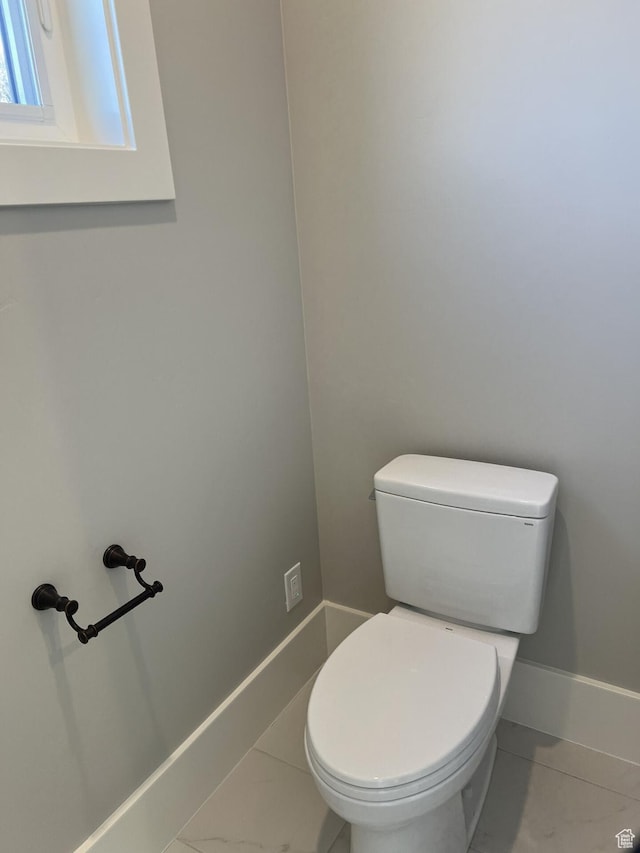bathroom with tile patterned flooring and toilet