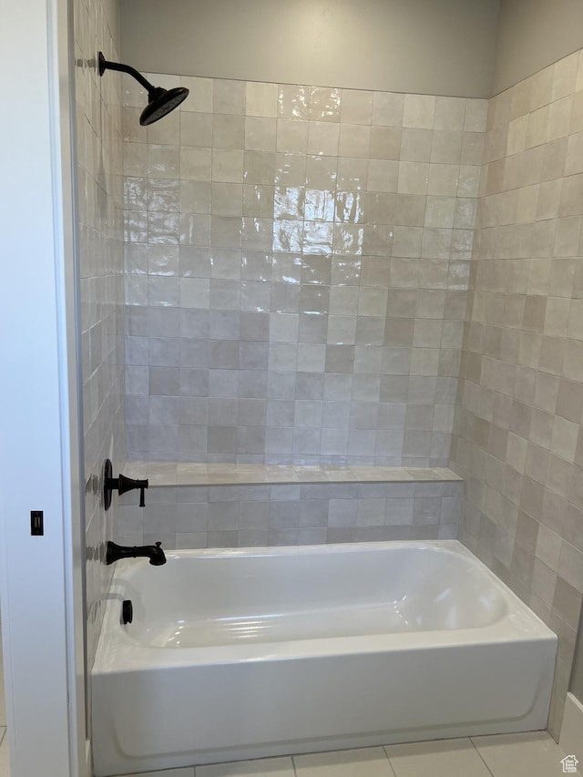 bathroom featuring tile patterned flooring and tiled shower / bath
