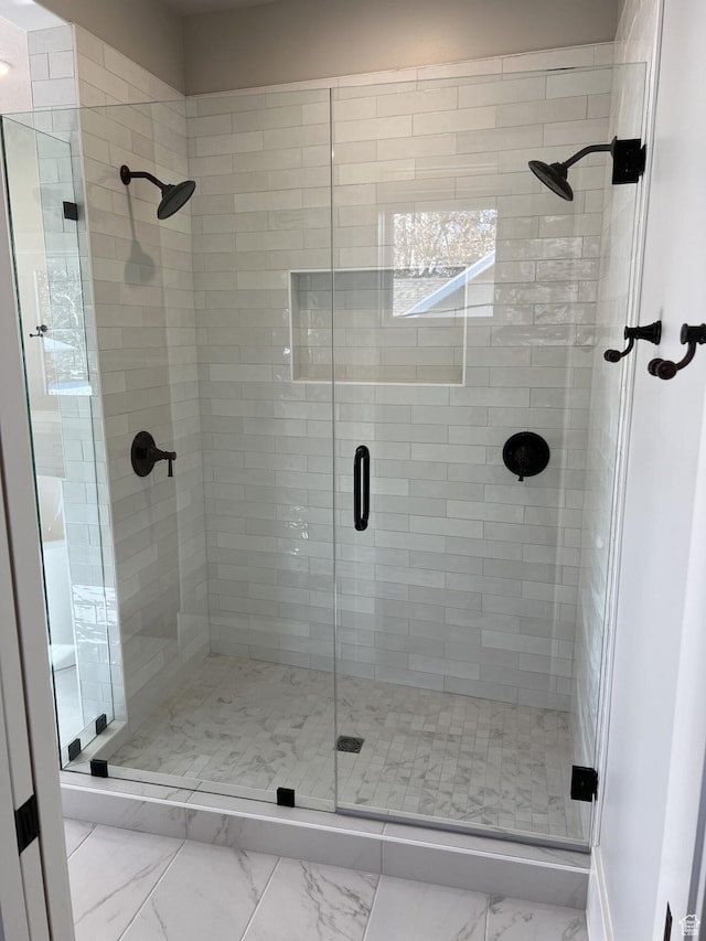 bathroom featuring a shower with door