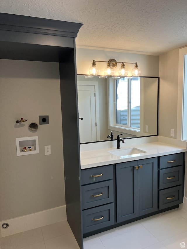 bathroom featuring vanity, tile patterned flooring, and a textured ceiling