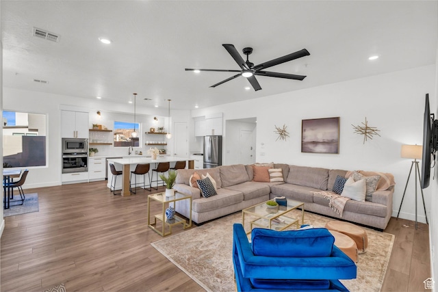 2227 N Double Eagle Ln, Washington, UT 84780 - living area featuring wood finished floors, a ceiling fan, and recessed lighting