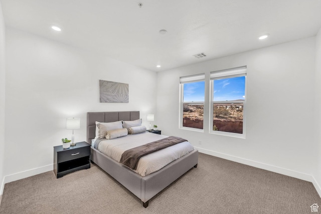 bedroom featuring light carpet