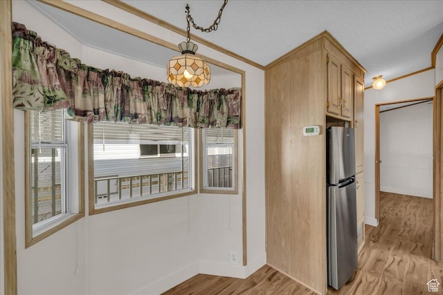 150 N 3050 E Unit 72, St George, UT 84790 - kitchen with a healthy amount of sunlight, light wood-type flooring, light brown cabinets, and stainless steel refrigerator