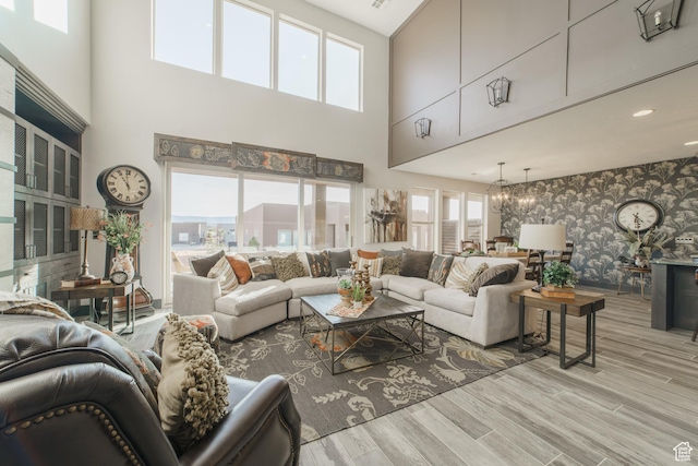 living room featuring a notable chandelier and light hardwood / wood-style floors