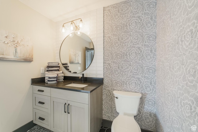 bathroom featuring vanity and toilet