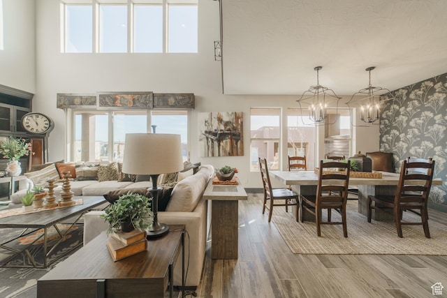 living room with wood-type flooring, a chandelier, and a wealth of natural light