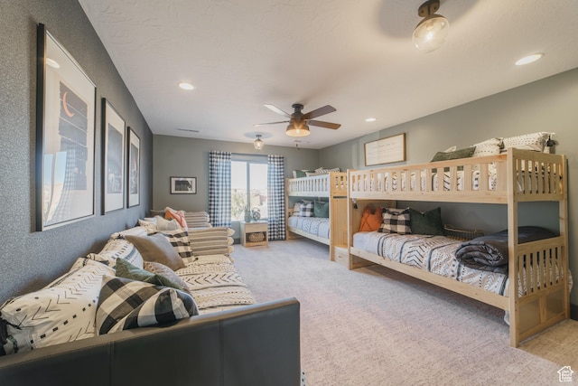 bedroom featuring ceiling fan and light carpet