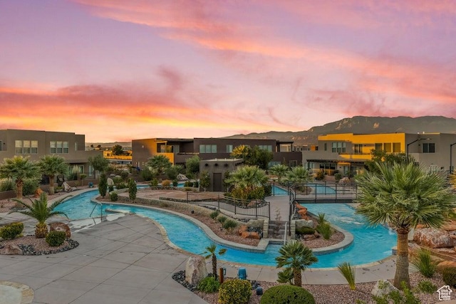 pool at dusk with a mountain view