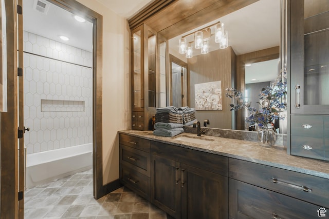 bathroom featuring vanity and tiled shower / bath