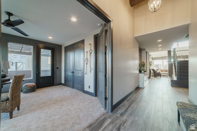 foyer entrance with hardwood / wood-style floors and ceiling fan