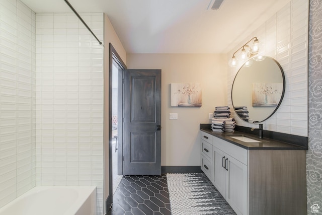bathroom with tile patterned flooring, vanity, and  shower combination