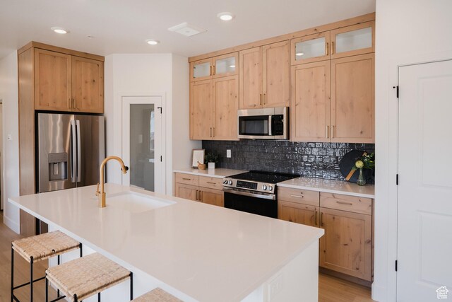 858 S 200 E Unit 3-204, Spanish Fork, UT 84660 - kitchen featuring a breakfast bar, tasteful backsplash, sink, stainless steel appliances, and a center island with sink
