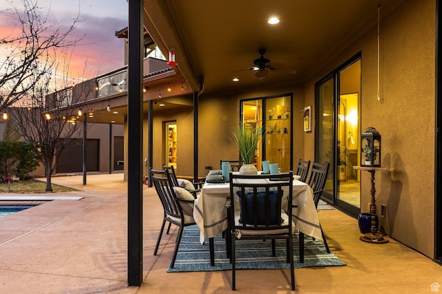 98 Bridge Rd, Rockville, UT 84763 - patio terrace at dusk featuring a ceiling fan, outdoor dining area, and an outdoor pool